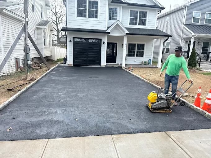 Crew spreading drainage fabric over a washed stone base