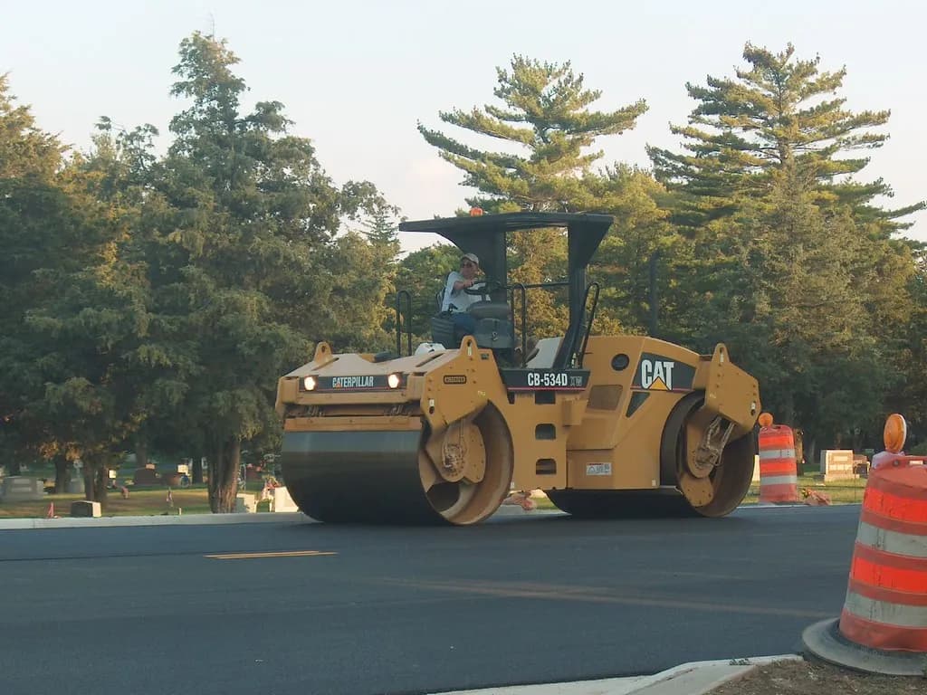 Road roller compacting a fresh layer of asphalt