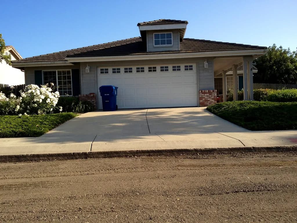 Asphalt driveway leading to a suburban home