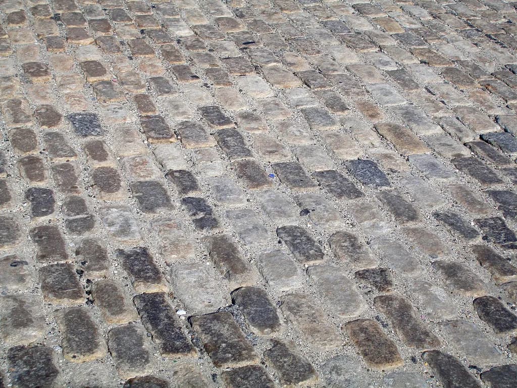 Interlocking concrete pavers in a herringbone pattern